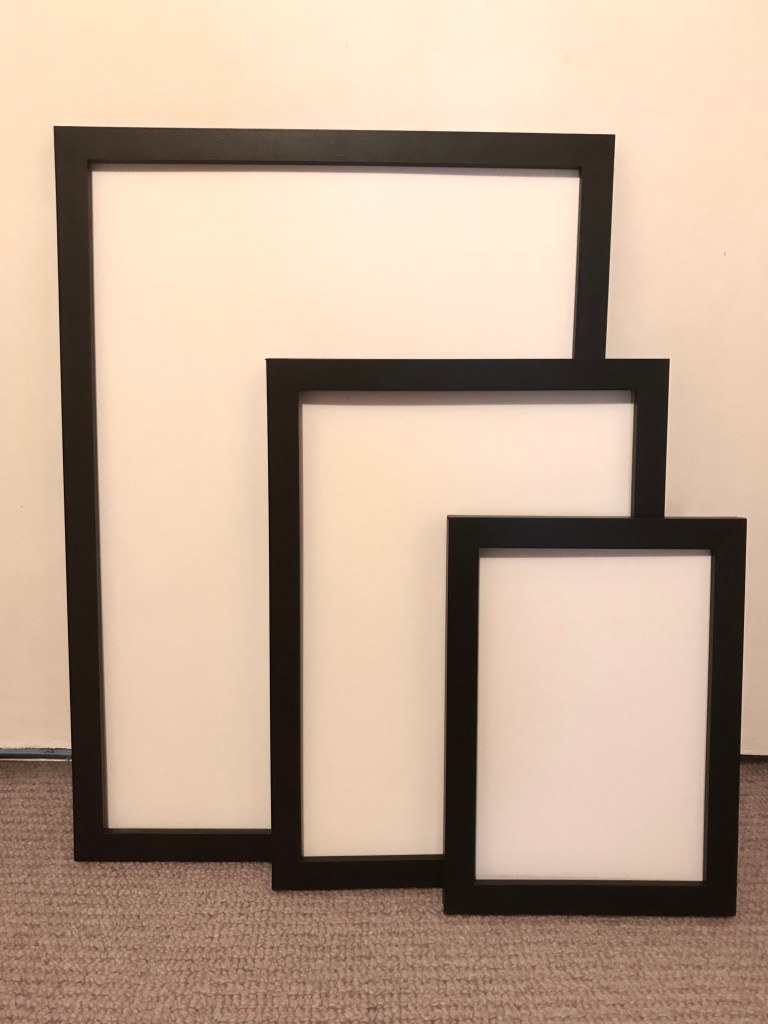 Three black frames of various sizes.