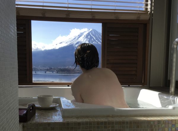 A photo of me in a bath with Mount Fuji visible through the window behind me. My back is turned so nothing exciting is visible lol.
